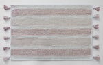 Soft blush striped bath mat underfoot