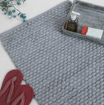 Pebble textured grey bath mat