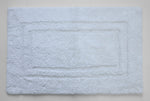 Soft white bath mat with plush surface