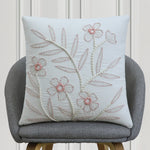 Pink and white floral embroidered cushion