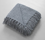 Woven throw with decorative tassel fringes