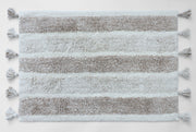 Plush striped bath mat with tassels