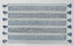 Tasselled bath mat with coastal tones