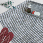 Grey and white striped bath mat