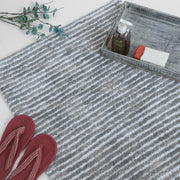 Grey and white striped bath mat