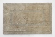 Plush beige bath mat with textured border