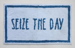 Blue and white text bath mat close-up