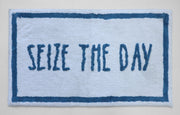 Blue and white text bath mat close-up