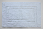 Soft white bath mat with plush surface