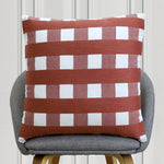 Rust and white checkered striped cushion