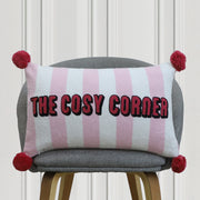 Striped embroidered cushion with pom-pom corners