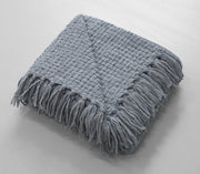 Woven throw with decorative tassel fringes