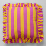 Decorative striped cushion with ruffle edges