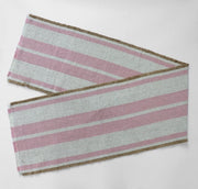 Woven striped table runner with fringed edges